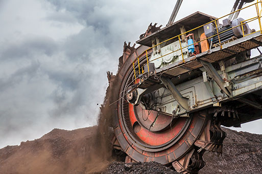 A large machine is moving through a coal mine