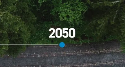 A road with trees and a blue line that says 2050