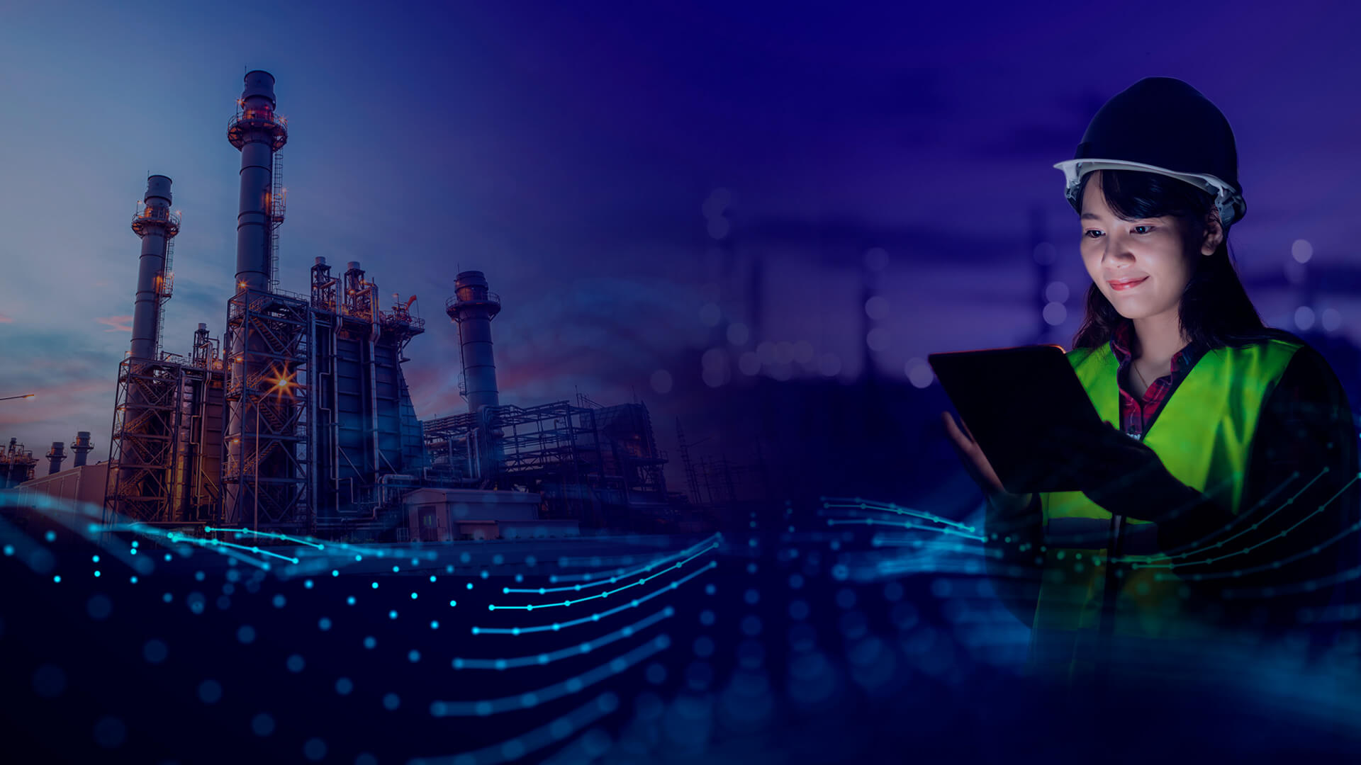 Person looking at screen with factory in background
