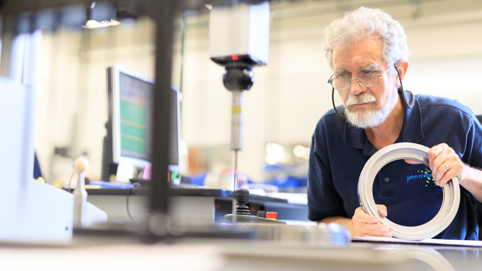 A man working on a circular object in a factory