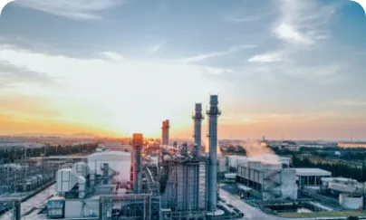 The sun sets over an industrial plant