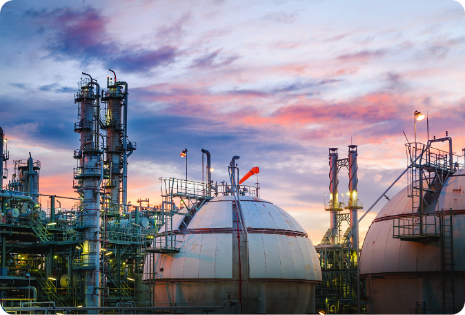 Oil and gas refinery against a dusky sky