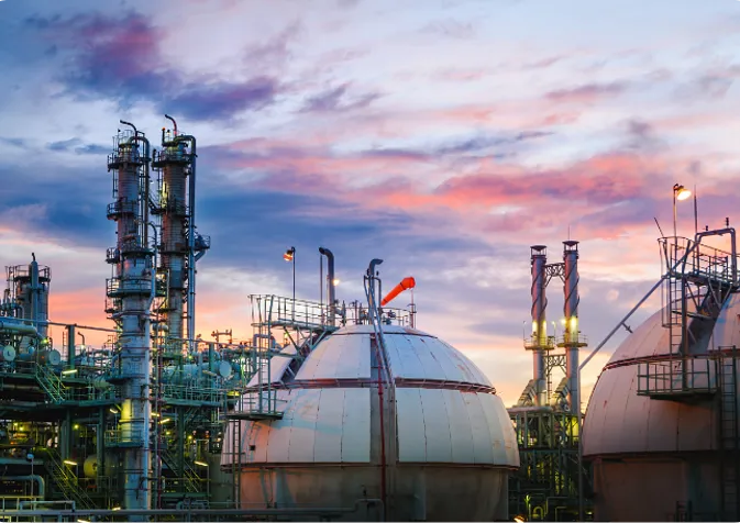 Oil and gas refinery against a dusky sky