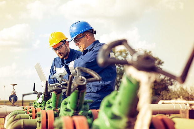 Employees On Site Using Laptop