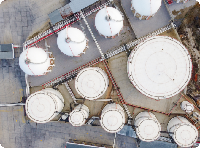 Aerial view showcasing the arrangement of multiple oil tanks situated at a gas station