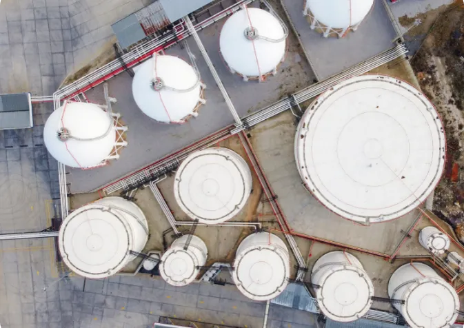 Aerial view showcasing the arrangement of multiple oil tanks situated at a gas station